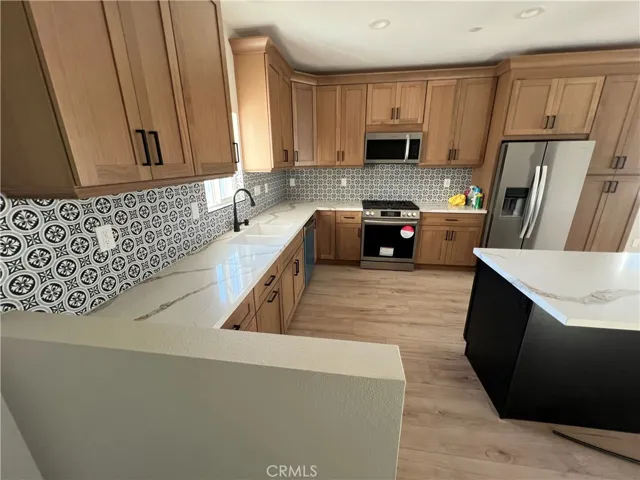 VIEW OF KITCHEN F 
 FROM REAR ENTRANCE