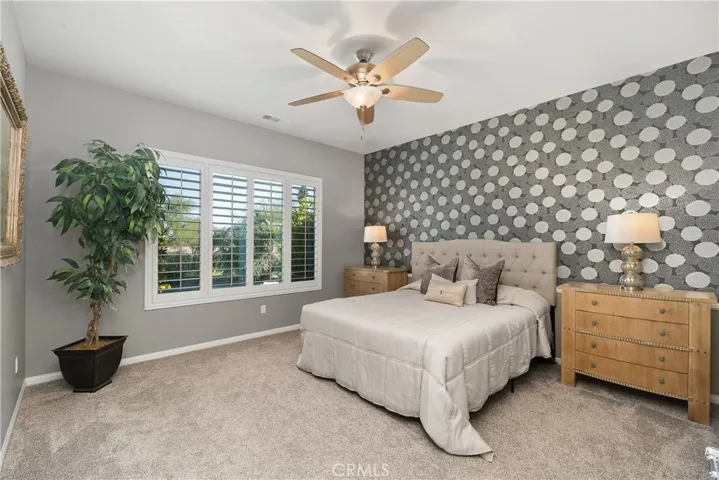 primary bedroom is like your own private retreat. location on the other end of the home, views from the picture window of the pool, and gold course and mountain views.