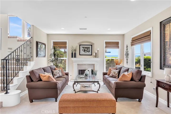 The living room is comfortable and inviting with high ceilings and ocean views.