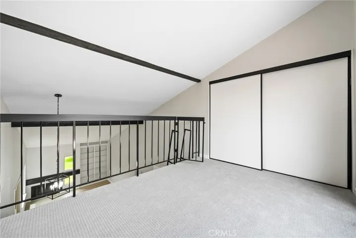 The loft offers a large closet, scraped ceilings, new carpet, and sliding doors to a second balcony!

