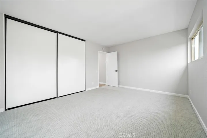 The primary bedroom has a nicely sized closet, new carpet flooring, and scraped ceiling!
