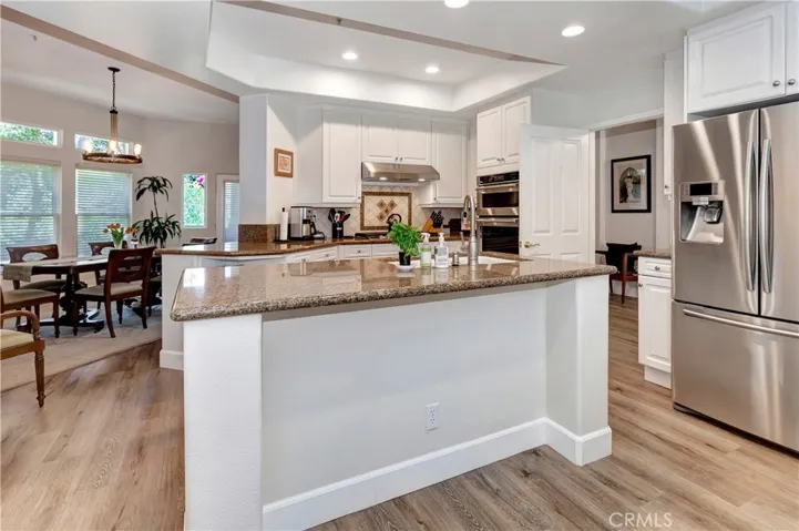 Kitchen with view of living room and trees