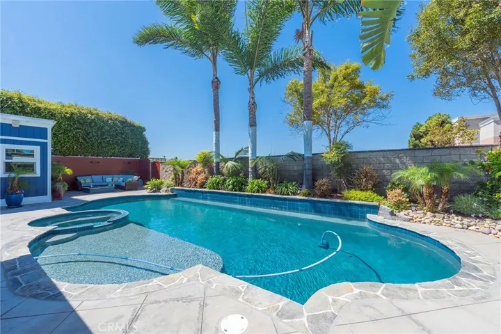 Backyard-pebble tech pool and custom tile updated in 2019.