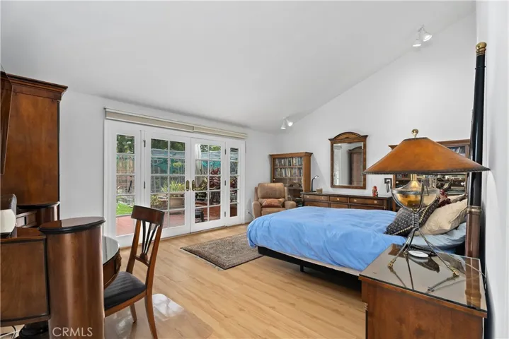 Primary bedroom overlooking the gardens with its own patio