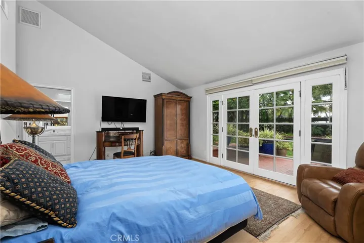 With French doors overlooking the lush landscaping