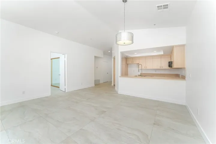 Great room with vaulted ceiling and sunset and mountain views