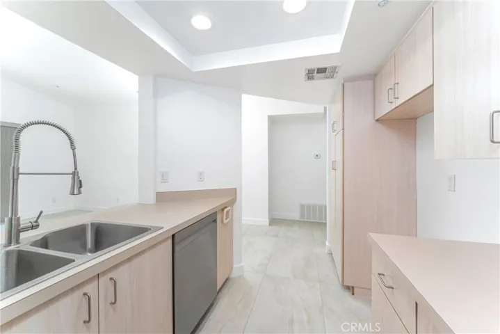 Renovated kitchen with new stainless steel gas range, microwave hood and dishwasher with large pantry