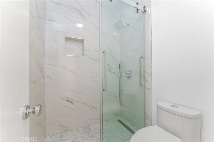 Bedroom suite two with vaulted ceiling and new bath with walk in shower