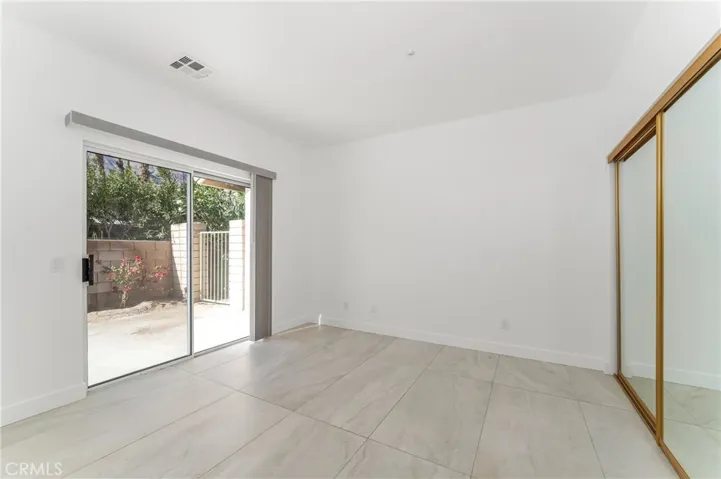 Bedroom suite two with vaulted ceiling. Opens to patio and has mountain and sunset view