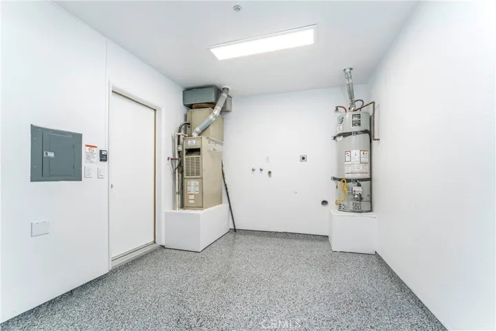 Fully finished garage with epoxy floor, steel back insulated garage door with MyQ wifi remote opener, and 220 Volt receptacle