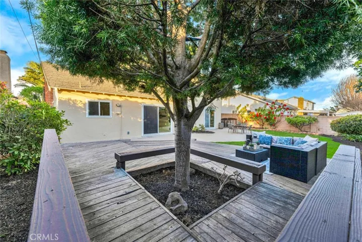 Large Sitting Area In Backyard Around Wood Deck