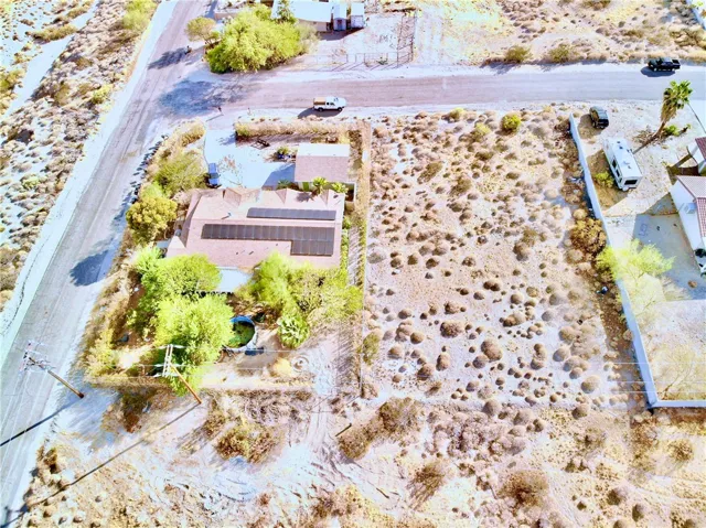 Rear view of home and adjacent lot.