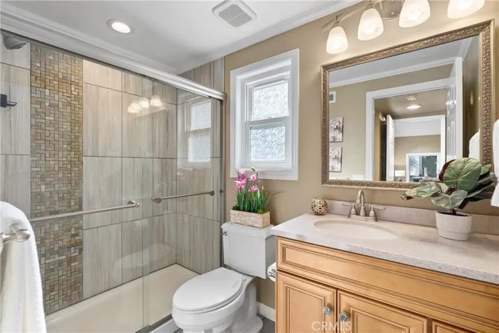 Downstairs bathroom with tiled-shower and updated vanity