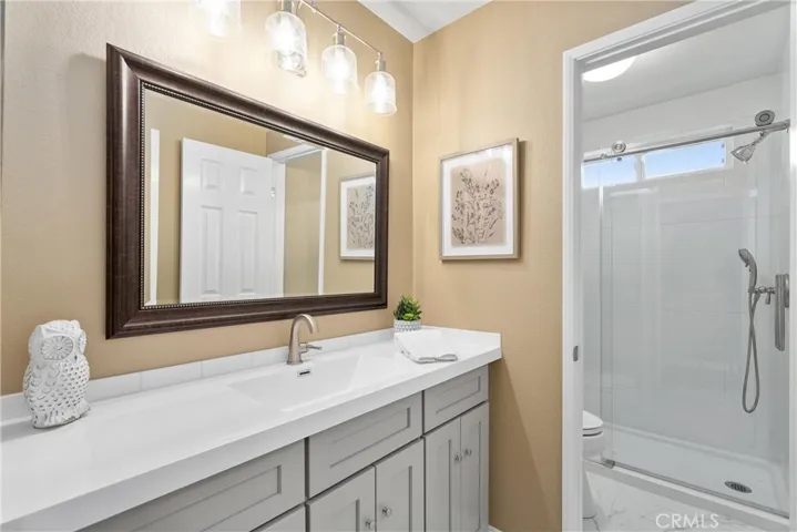 Updated bathroom with dual showerhead and updated vanity