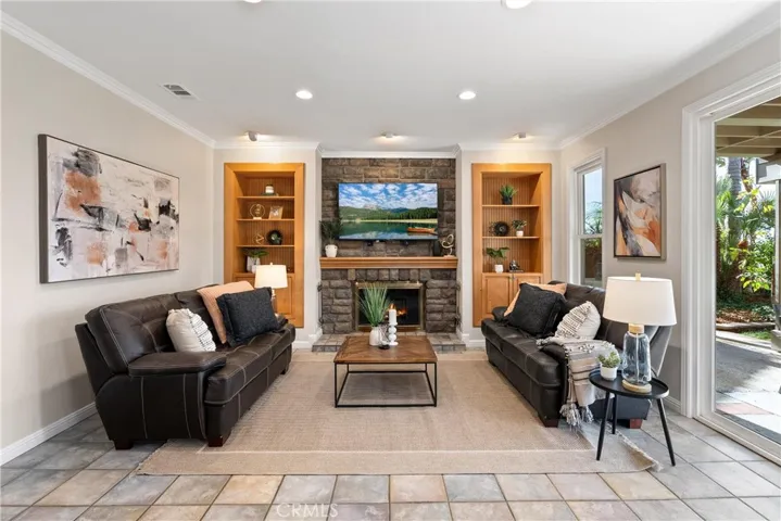Family Room with block-wall fireplace and inset Maple bookshelves & cabinets
