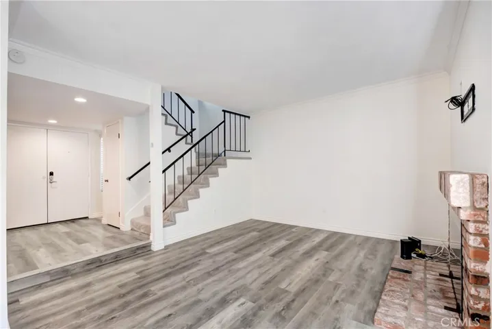 Living room; fire place to the right; newer engineered flooring; ALL NEW PAINT INSIDE