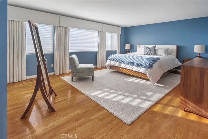 Primary Bedroom with a large walk-in closet with custom California Closets fixtures.  All window treatments in the home are Hunter Douglass.