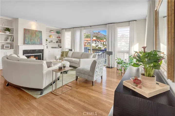 View of the second story Living Room with fireplace and outside balcony. Note the gorgeous hardwood floors throughout this level.
