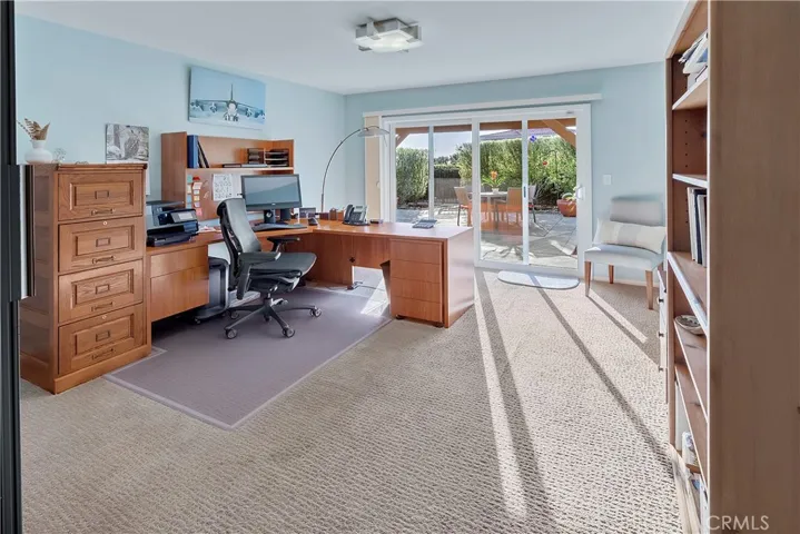 Bedroom number three currently used as an office and has wonderful access to the outside backyard.