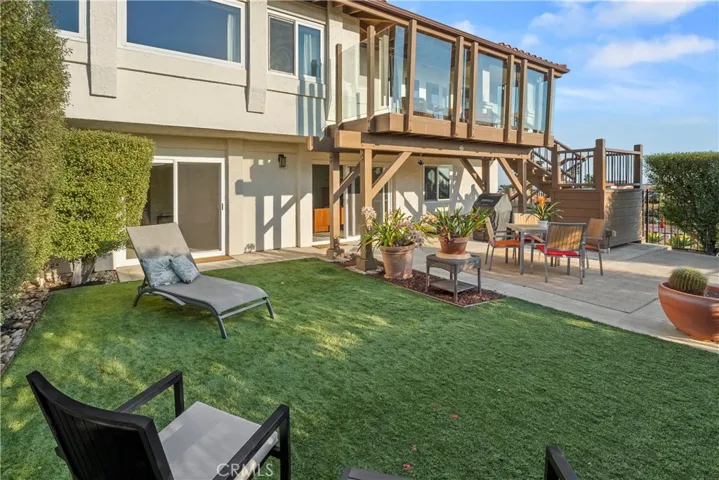 Partially covered sun patio and very private backyard.