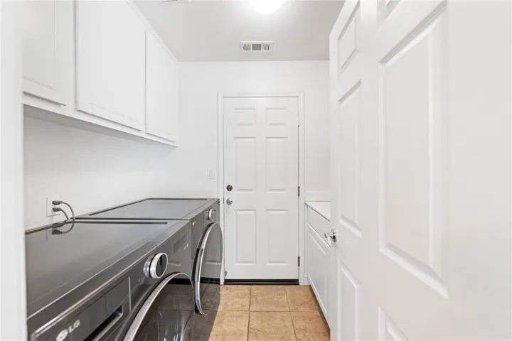 Main floor laundry with sink & storage
