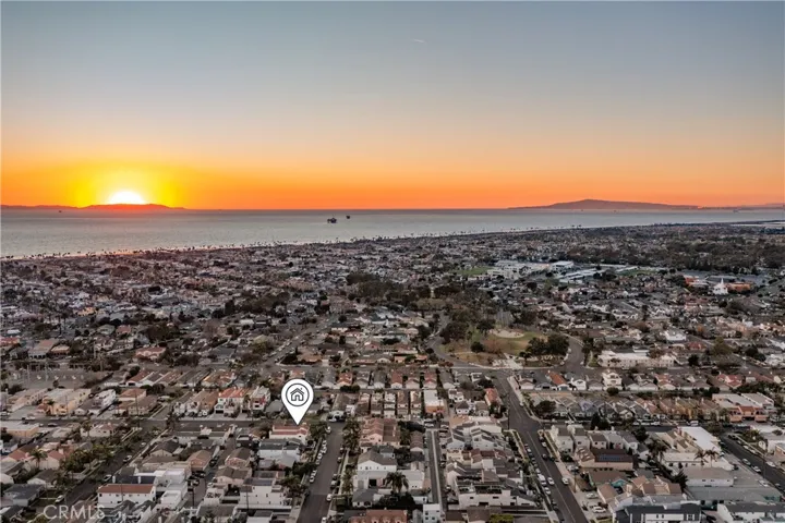Sun sets behind Catalina Island and Palos Verdes on the right.