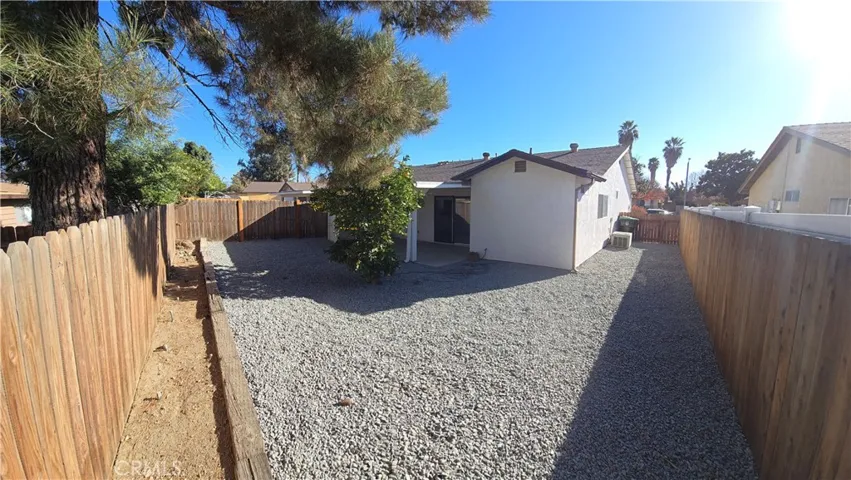 Back yard with easy to maintain rock landscape and Orange Tree!