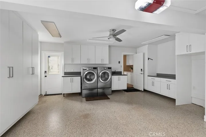Fully finished garage with cabinetry.