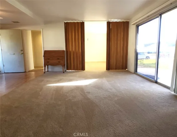 Showing Convertible Den with Sliding Teak Doors Partially Closed.