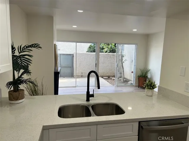 NEW KITCHEN COUNTERS SHOW OPEN INTO THE PATIO AREA