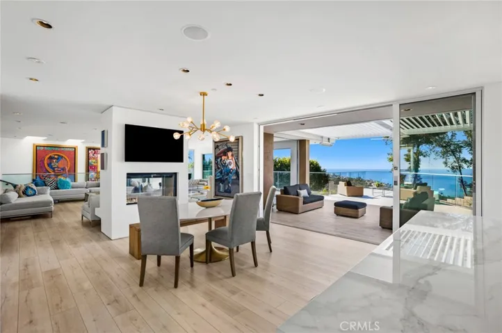  Ocean views greet everyone upon entering the exceptionally light and open home, which is primed for entertaining with large living areas that open to a grand ocean-view deck, and a newly remodeled kitchen that is anchored by a double-waterfall island with under-counter beverage refrigerator, an ice maker, quartz countertops, sleek white cabinetry and a secondary catering kitchen.