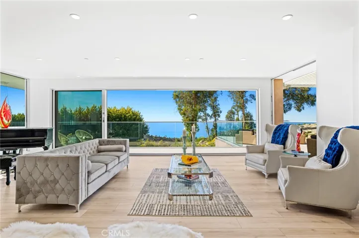 Breathtaking views of the Pacific Ocean, dramatic coastline, Catalina Island, rolling hills and evening lights are enjoyed from this iconic Mark Singer-designed custom contemporary pool home in Laguna Beach.