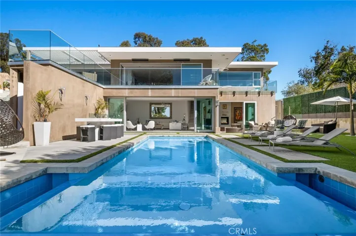 The exquisitely upgraded and expanded residence resides behind the gates of Sommet Du Monde at the top of Laguna Beach, where only seven homes share this remarkably private setting.