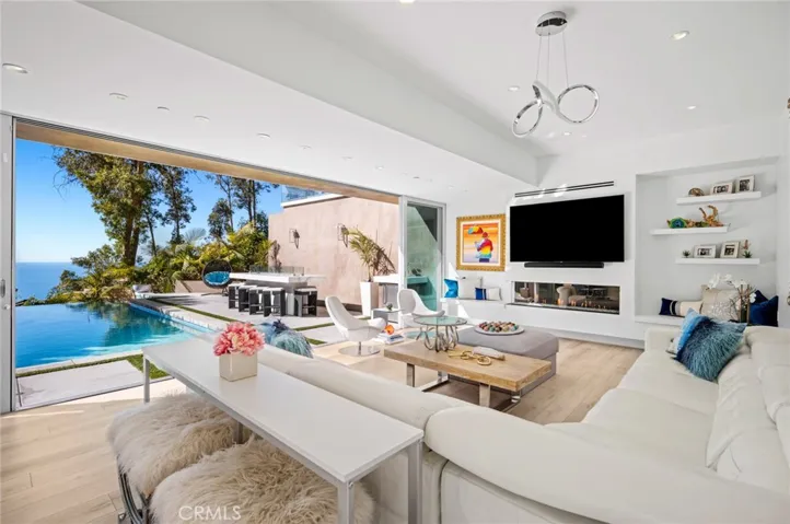  Downstairs, a versatile oversized bonus room offers ocean views and opens to the backyard’s pool and spa, providing a great spot for movie night.