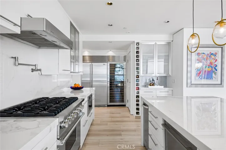 Two Fisher & Paykel dishwashers, a full-size wine refrigerator, Sub-Zero refrigerator and a Viking range with pot filler make this a true chef's paradise.