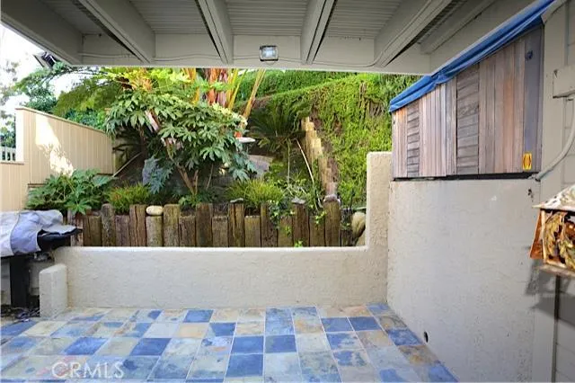 Outdoor patio with BBQ off the living room.
