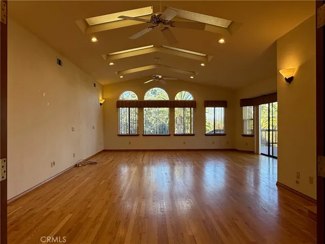 Multipurpose room with hardwood floors, two ceiling fans, lots of natural light. Would make a wonderful game room or pool table room, craft room, second family room, media room, or anything where you needs lots of room!