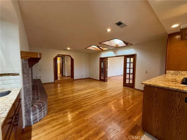 Family Room: fireplace, wet bar, open to kitchen on right, open to the multipurpose room through the double French doors, open to the central hallway