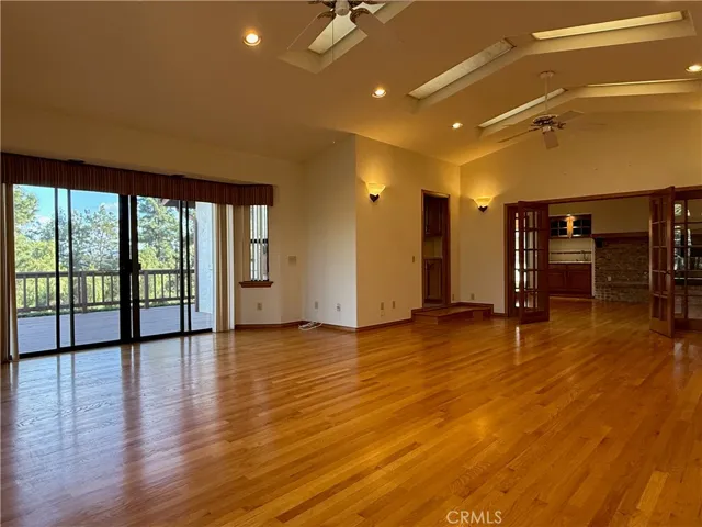 Multipurpose room with sliding doors to the wrap around deck, double French doors to the family room, single door to the breakfast nook, and a single door to the front hallway (not pictured - to the right)