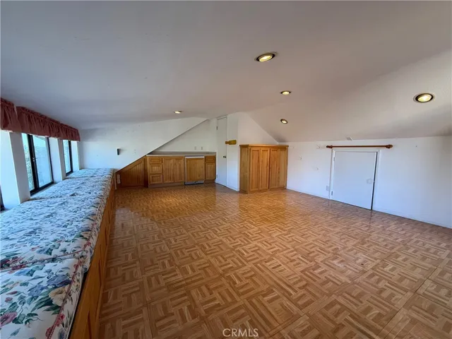 Living quarters/bonus room/hobby room with window seat storage along entire length of room