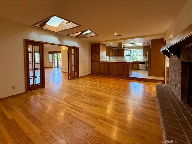 Family Room with skylights, open to multi-purpose room through French Doors