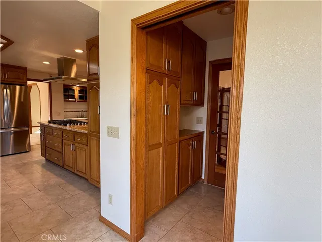 Doorway to Butler's Pantry on left, passthrough to multipurpose room straight ahead, and 1/2 bath to the right (not visible in this photo)