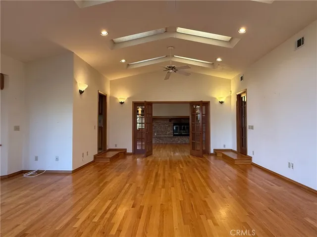 Multipurpose room with door to breakfast nook (left), family room (straight ahead through French doors) and front hallway (right)