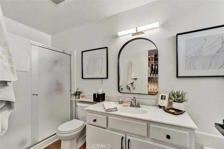 Bathroom #2: Primary bathroom with walk in shower, tub and another vanity area outside the bathroom.