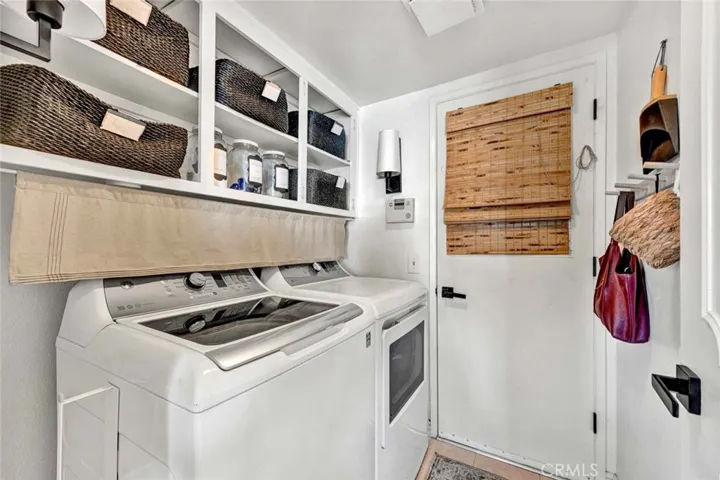 Laundry room with shelves. Pass thru to 3 car garage.