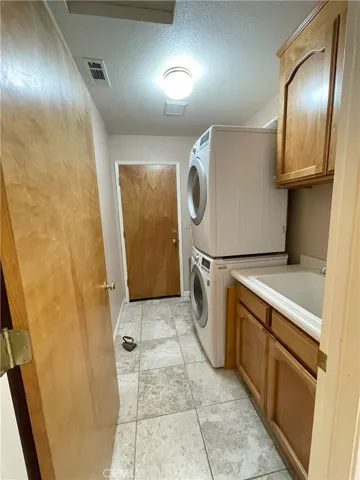 Laundry area with door to garage from hallway.