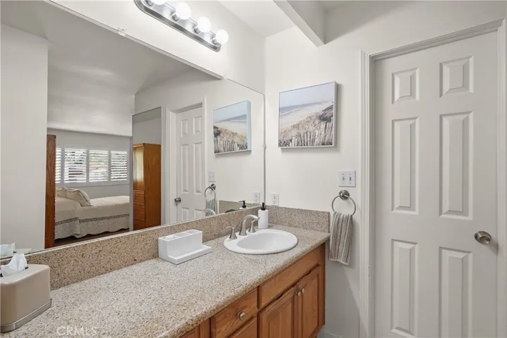 Primary bath basin with door to walk-in closet