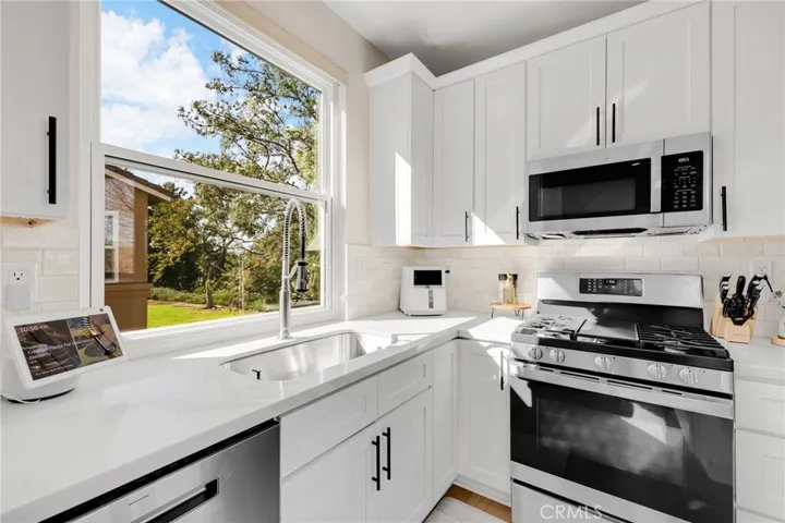 Beautiful highly upgraded kitchen with quartz counter tops