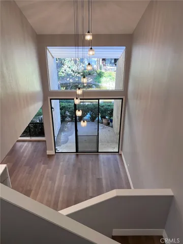 Livingroom with two-story ceiling and patio outside.
