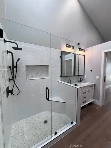 One of the two primary bathrooms with walk-in shower and double sinks.
